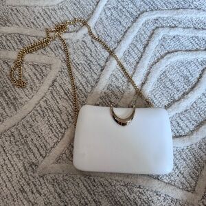 White clutch with gold chain